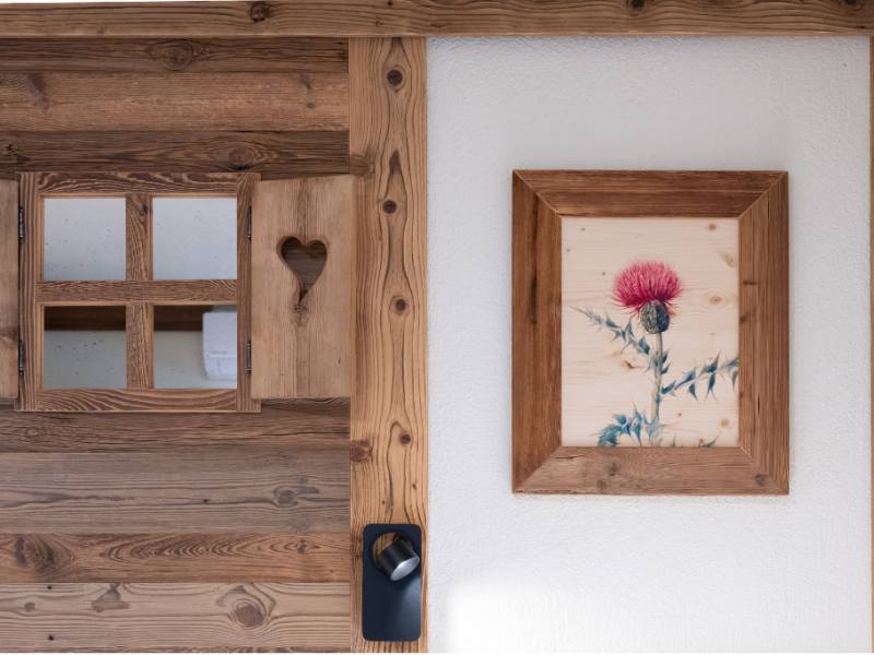 Wooden door with window and pink flower painting.